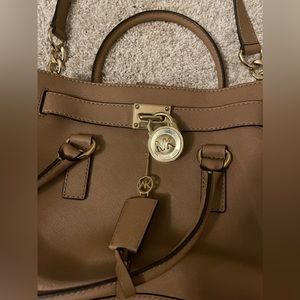 MK Michael Kors brown purse with lock and key
